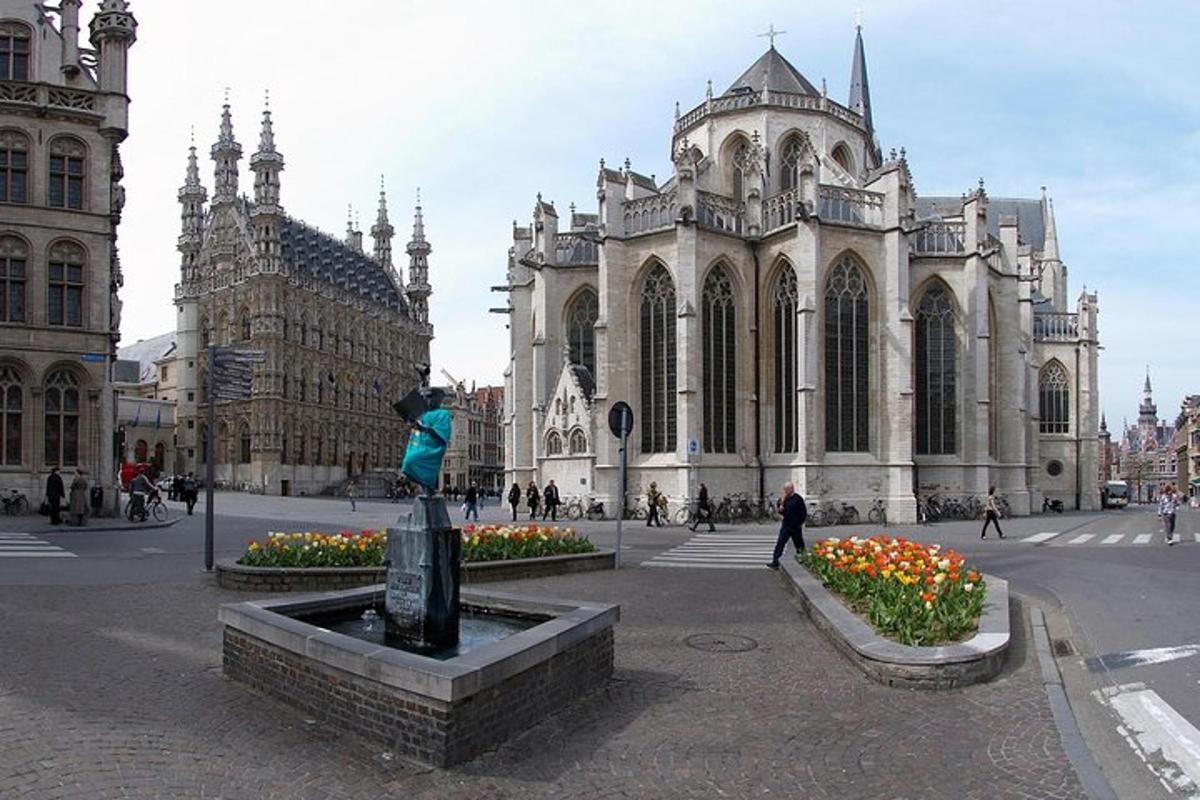 a statue in front of a building with a church