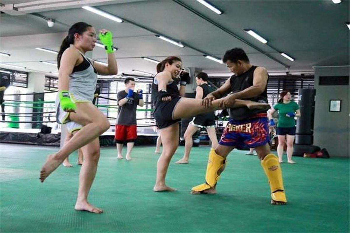 a group of people dancing in a boxing ring