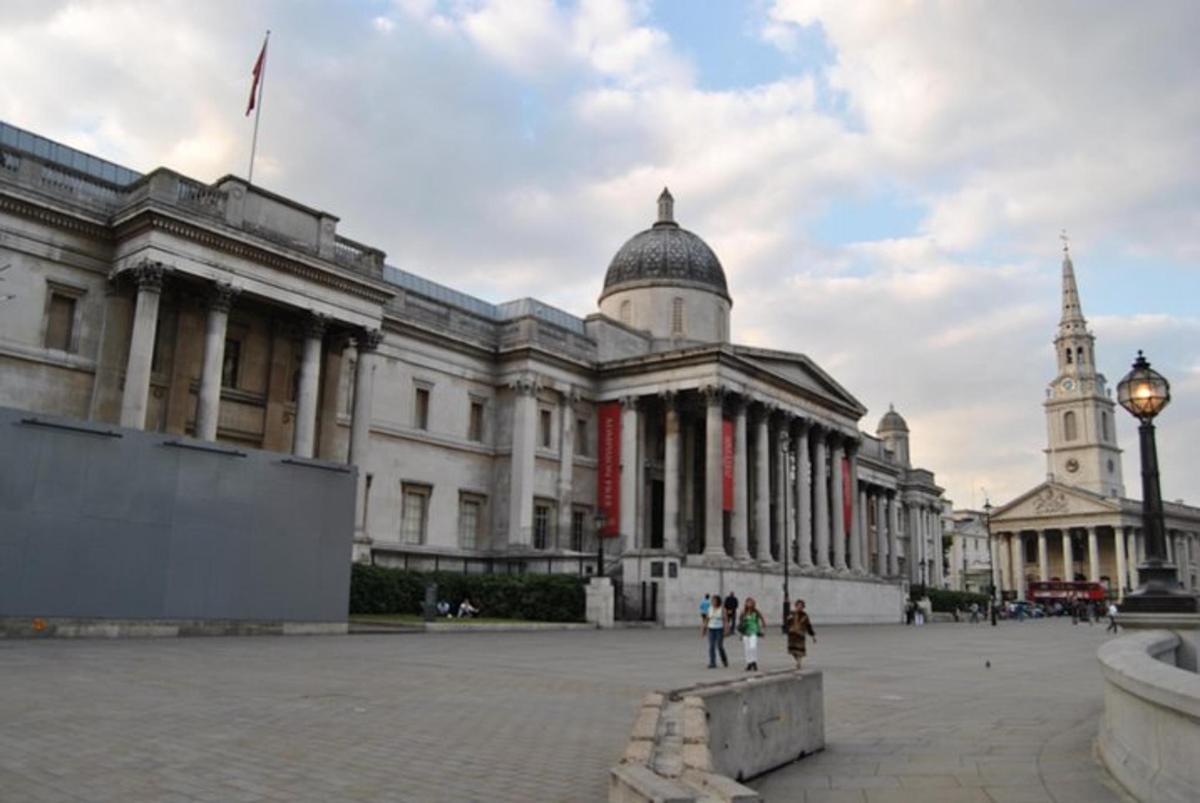 a large building with people walking in front of it