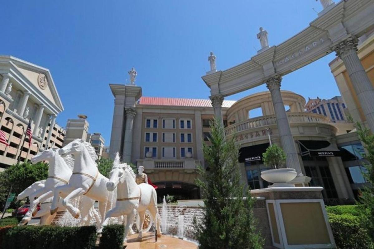 a statue of white horses in front of a building