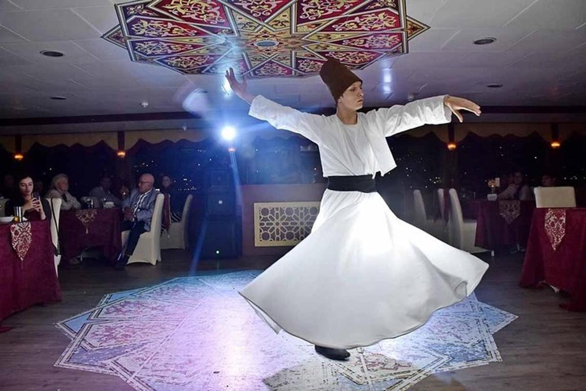 a man in a white dress dancing on a dance floor