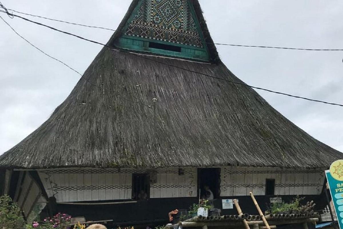 a building with a thatched roof with a sign on it