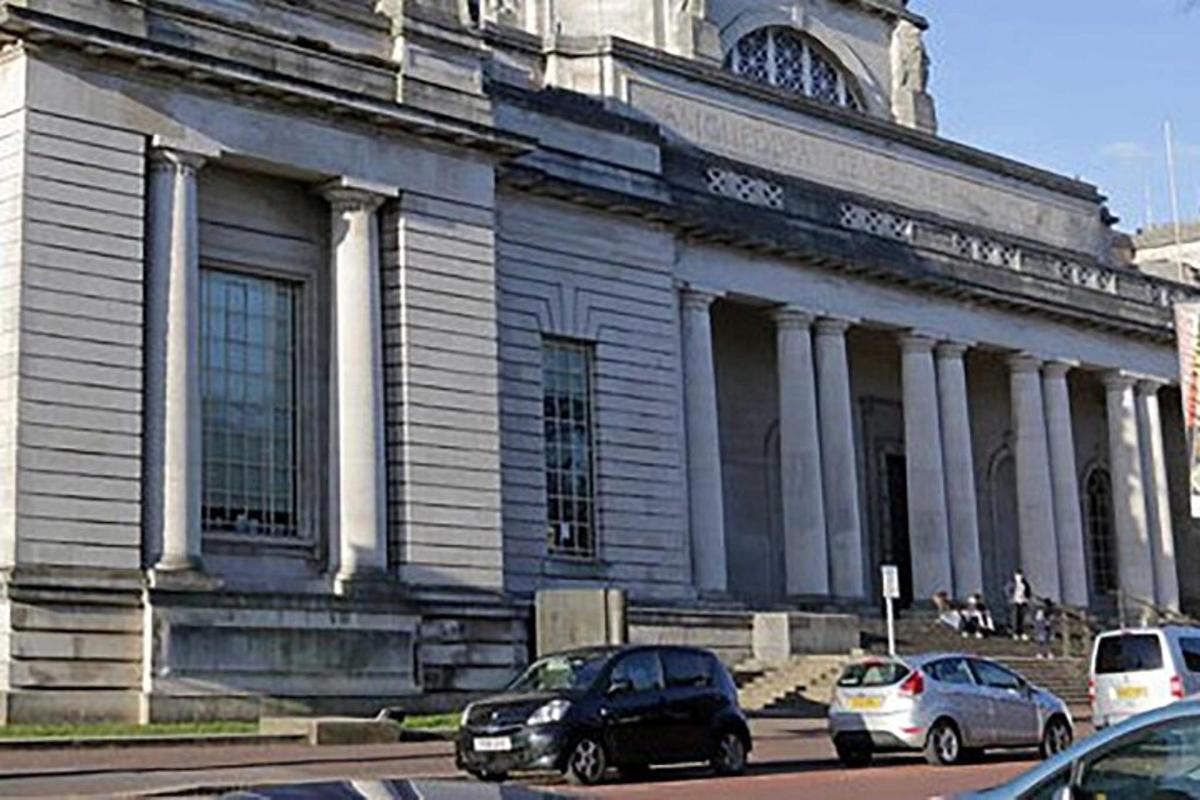 a large building with cars parked in front of it