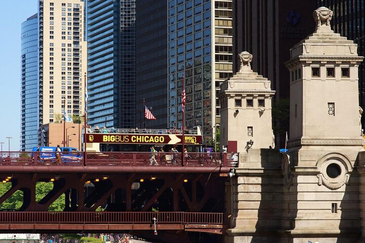 a train on a bridge in a city with tall buildings