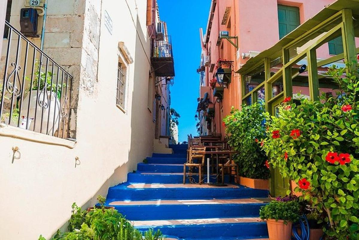 a set of blue stairs in a town with flowers