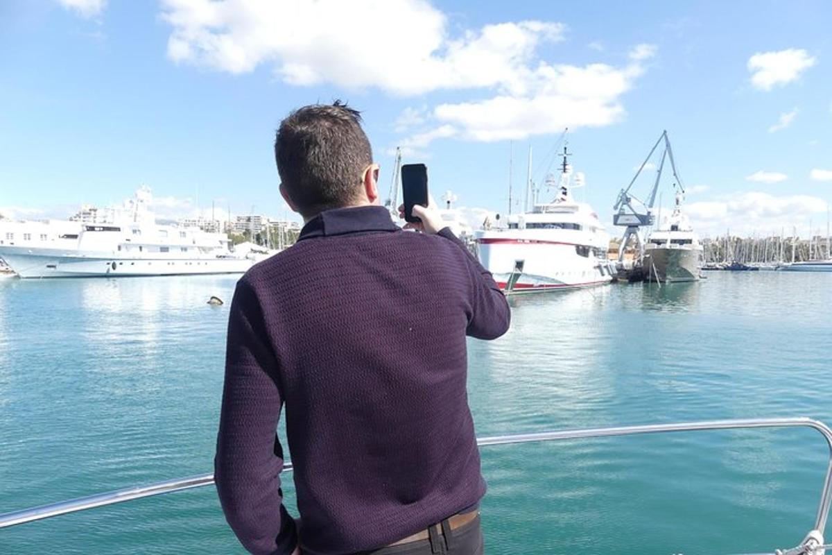 a man taking a picture of boats in the water