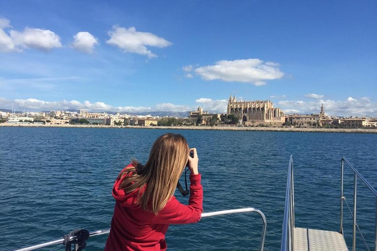 a woman on a boat taking a picture of a city