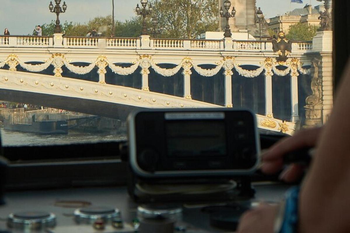 a person holding a cell phone in front of a bridge