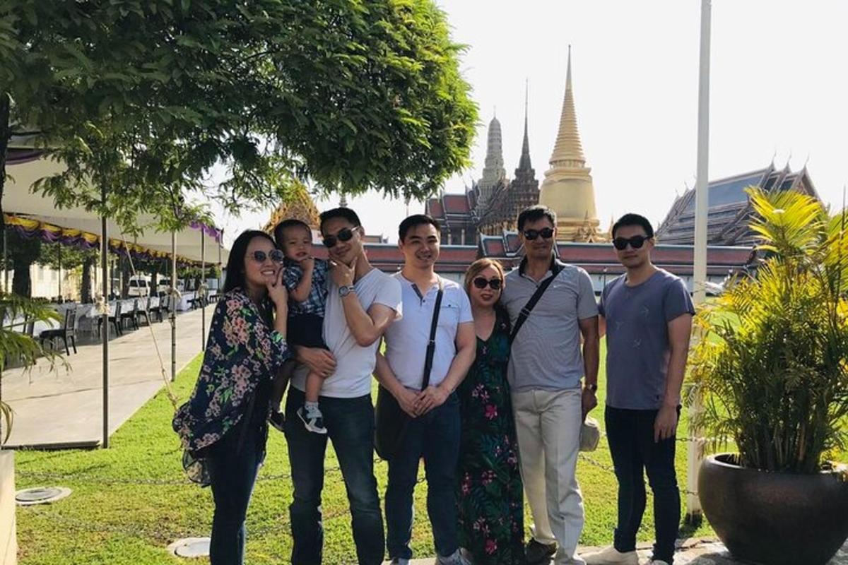 a group of people posing for a picture in a park