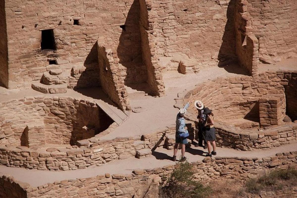 two people are standing in the ruins of a stone building