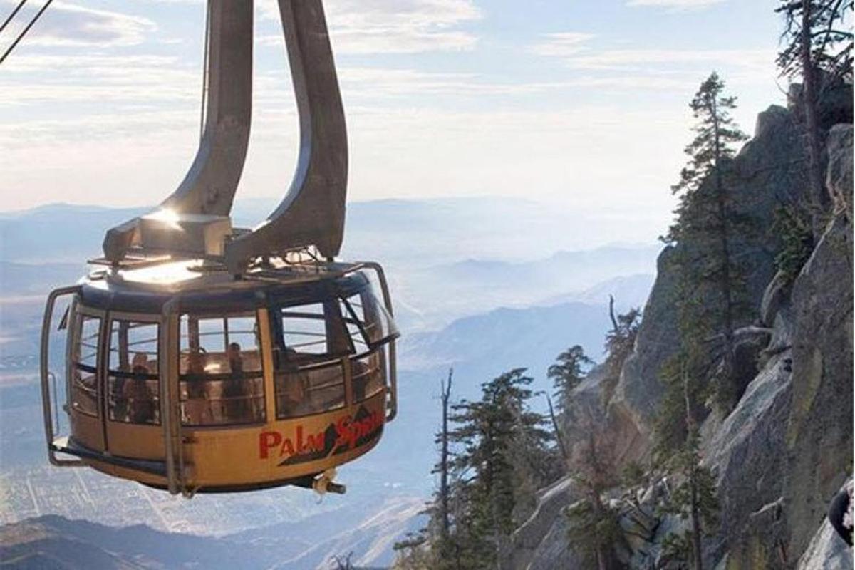 a gondola flying over a mountain
