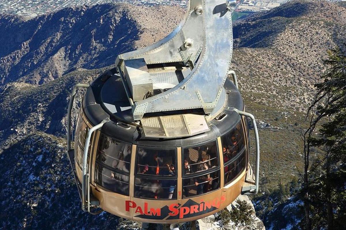 a cable car flying over a mountain