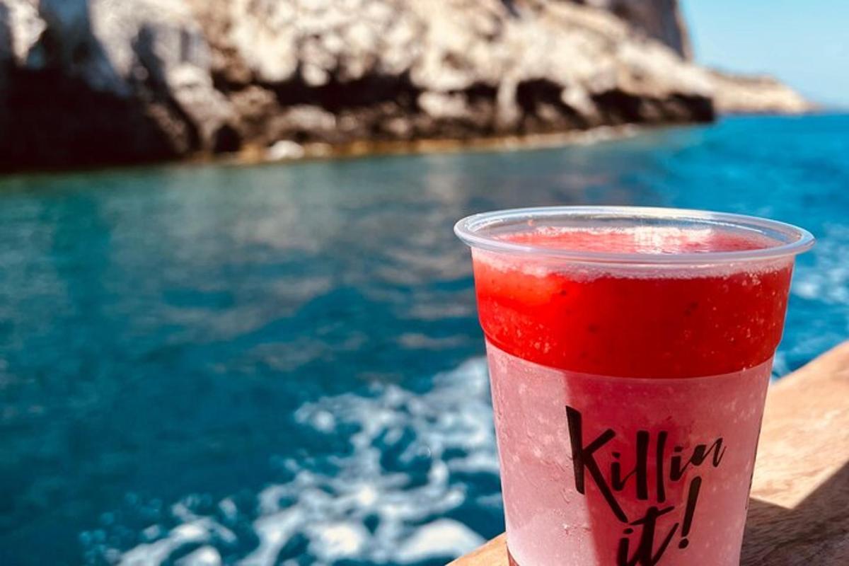 a drink sitting on a table next to the water
