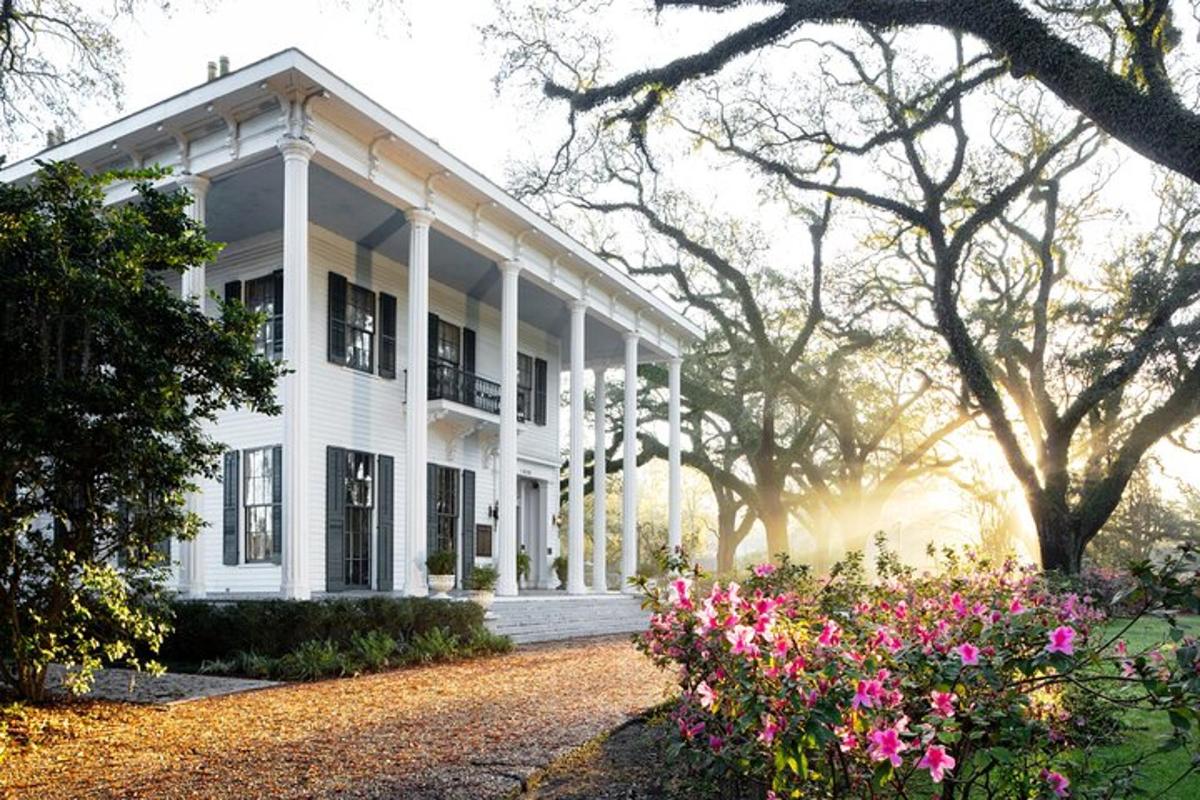 a white house with flowers in front of it