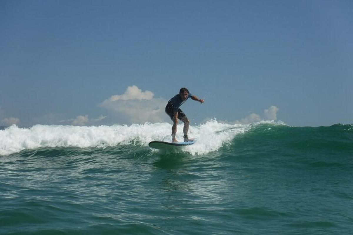 a man riding a wave on a surfboard in the ocean