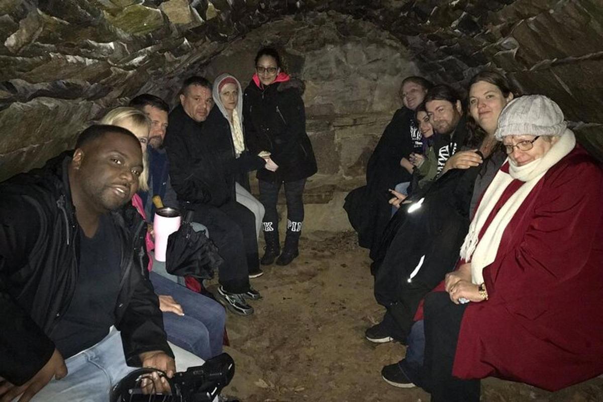 a group of people sitting in a cave
