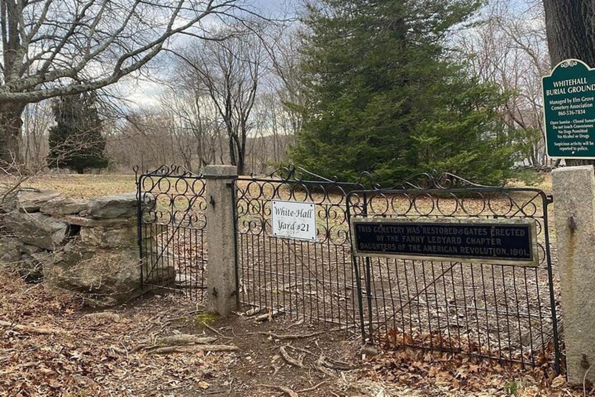 a gate in a park with a sign on it