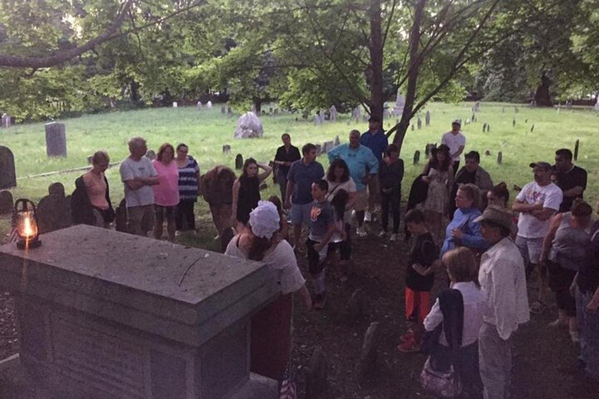a group of people standing in a crowd in a cemetery