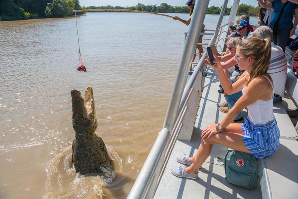 a group of people on a boat with a hippo in the water