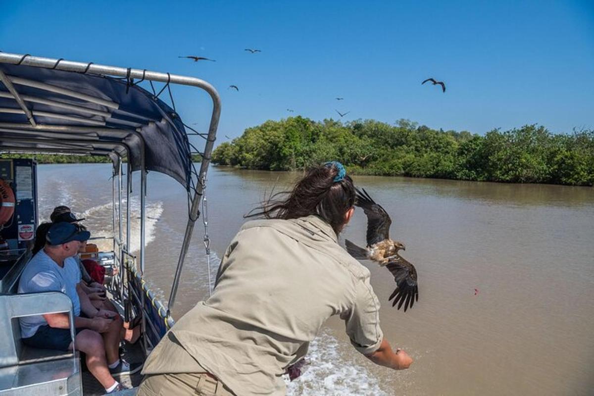 a person on a boat with a bird in the water