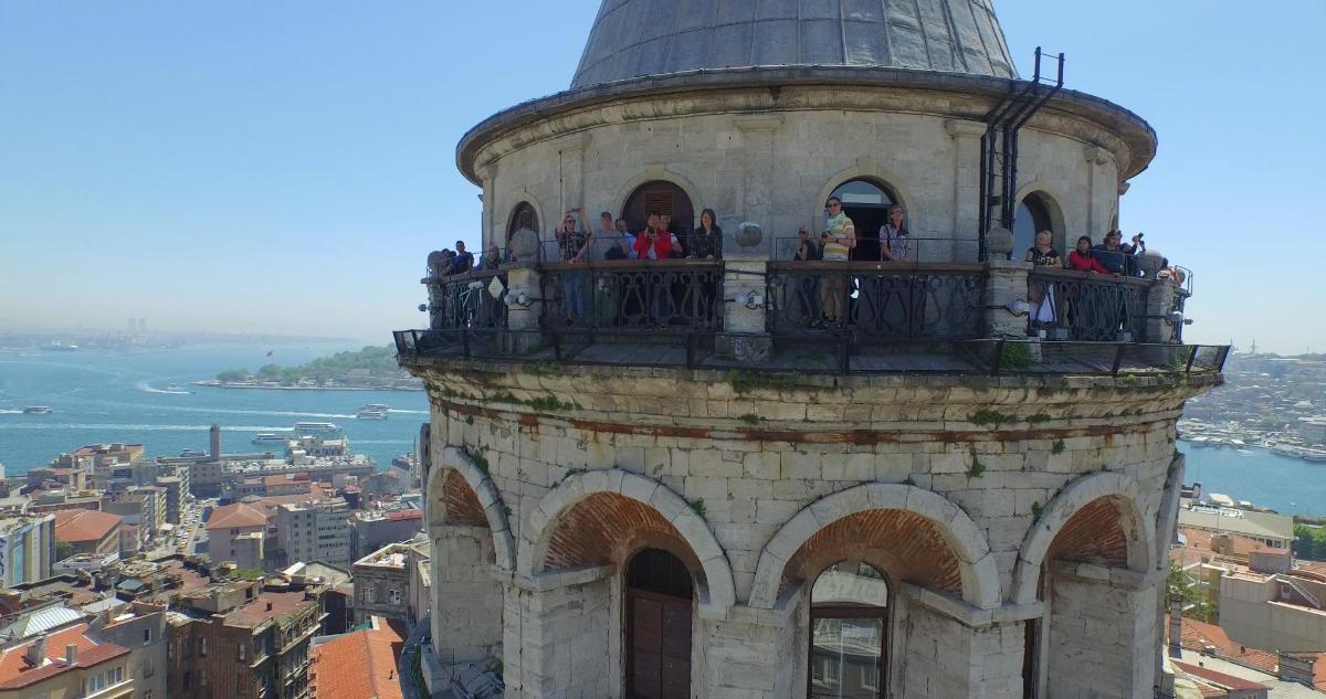 a group of people standing on top of a tower