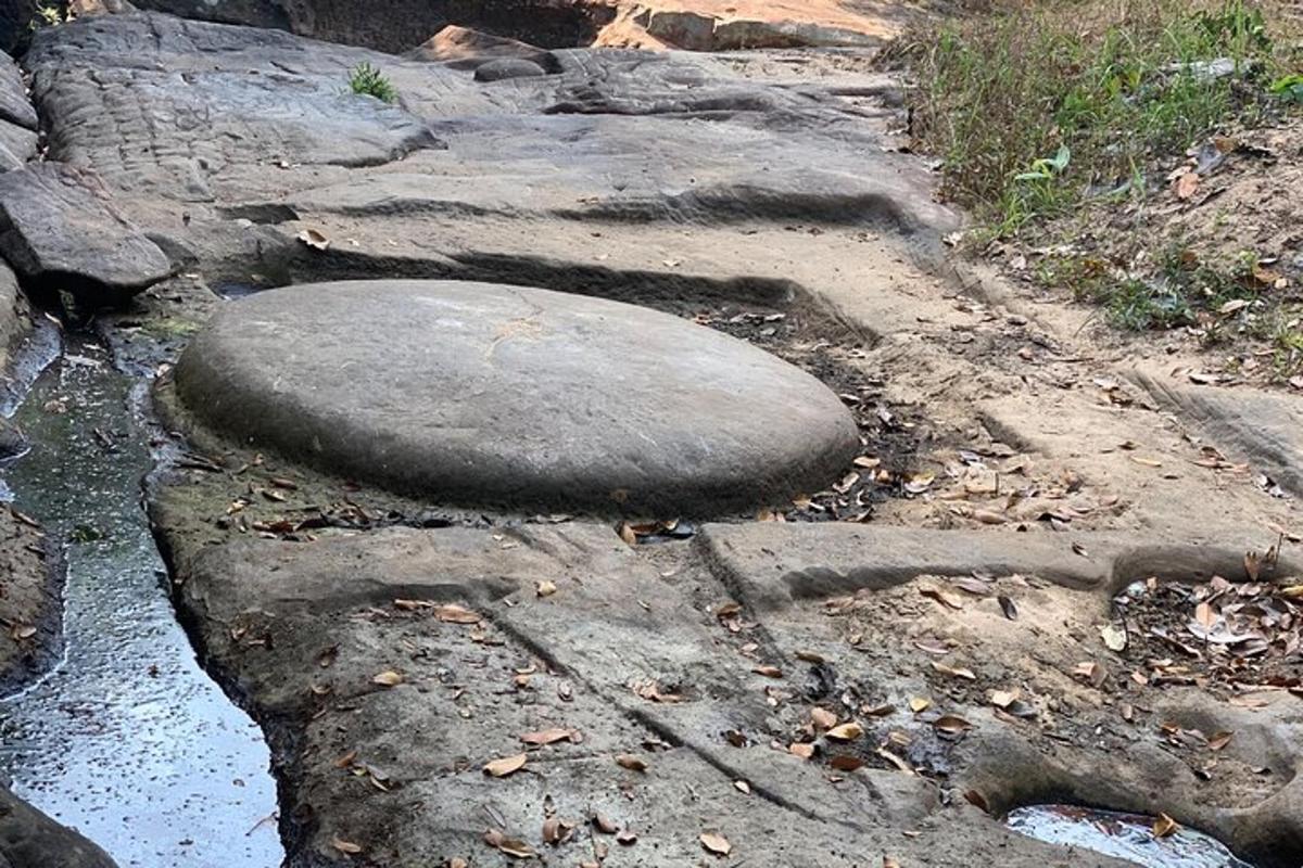 a rock sitting on the side of a road
