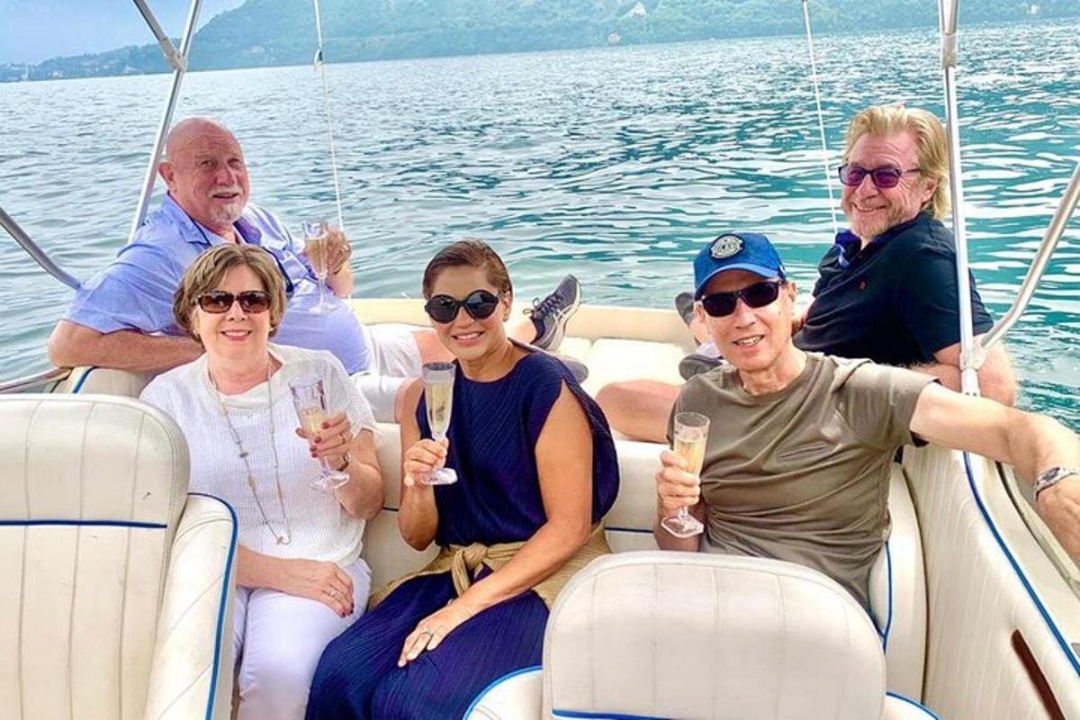 a group of people sitting in the back of a boat