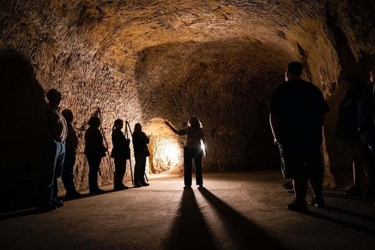 a group of people standing in a dark tunnel
