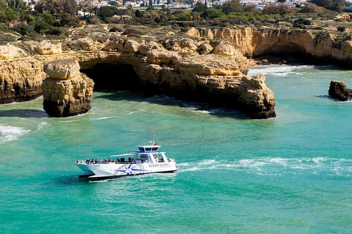 a boat in the water in front of a cave