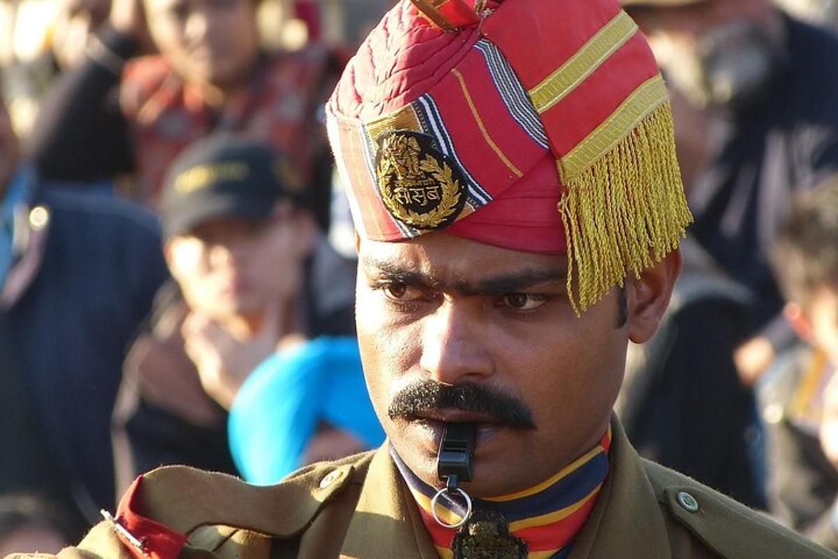 a man wearing a turban and talking on a cell phone