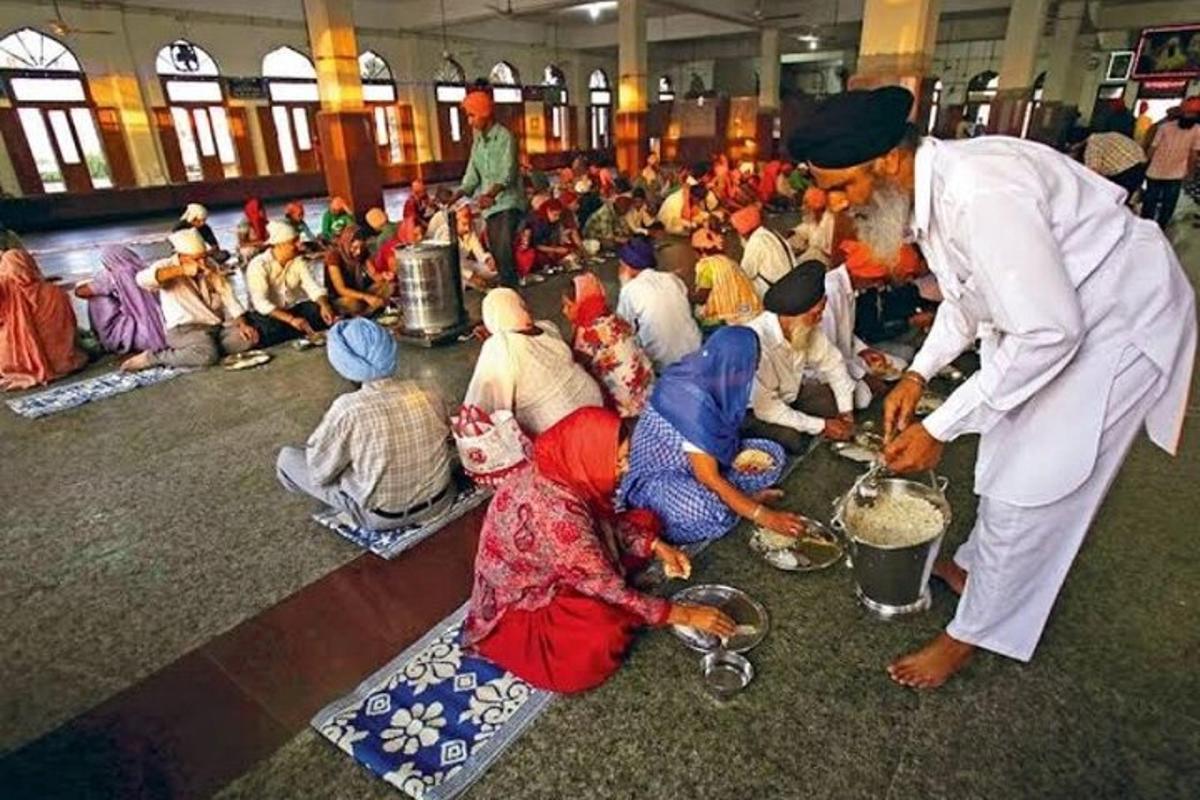 a group of people sitting on the floor eating food