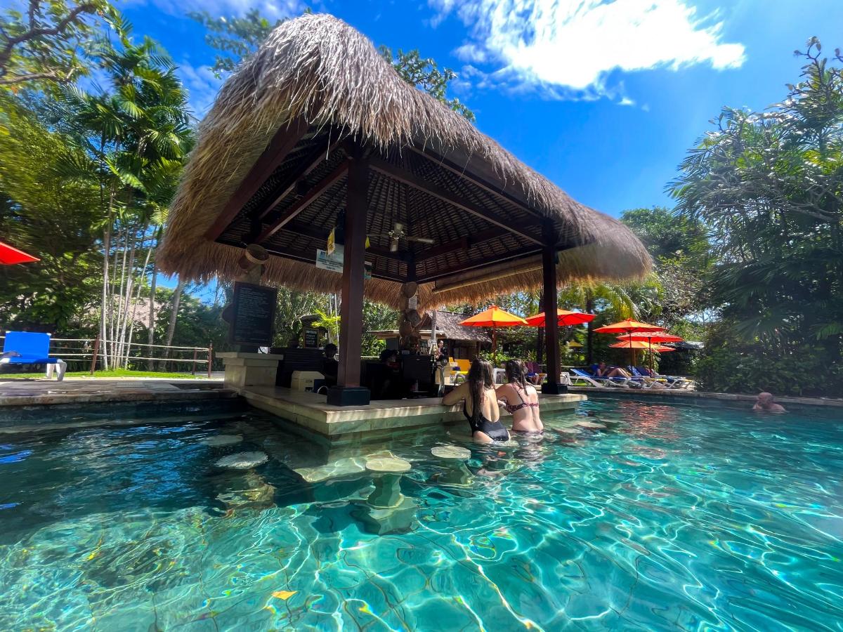 a pool at a resort with people in the water