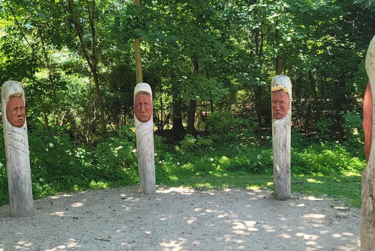 three statues of people with their faces on them