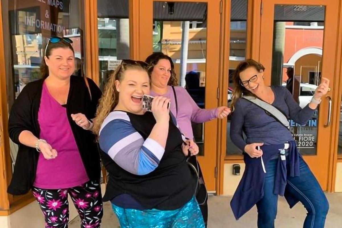 a group of women standing in a building