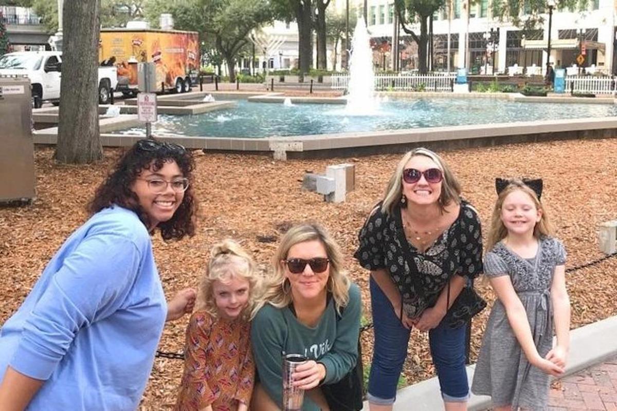 a group of people standing in front of a fountain