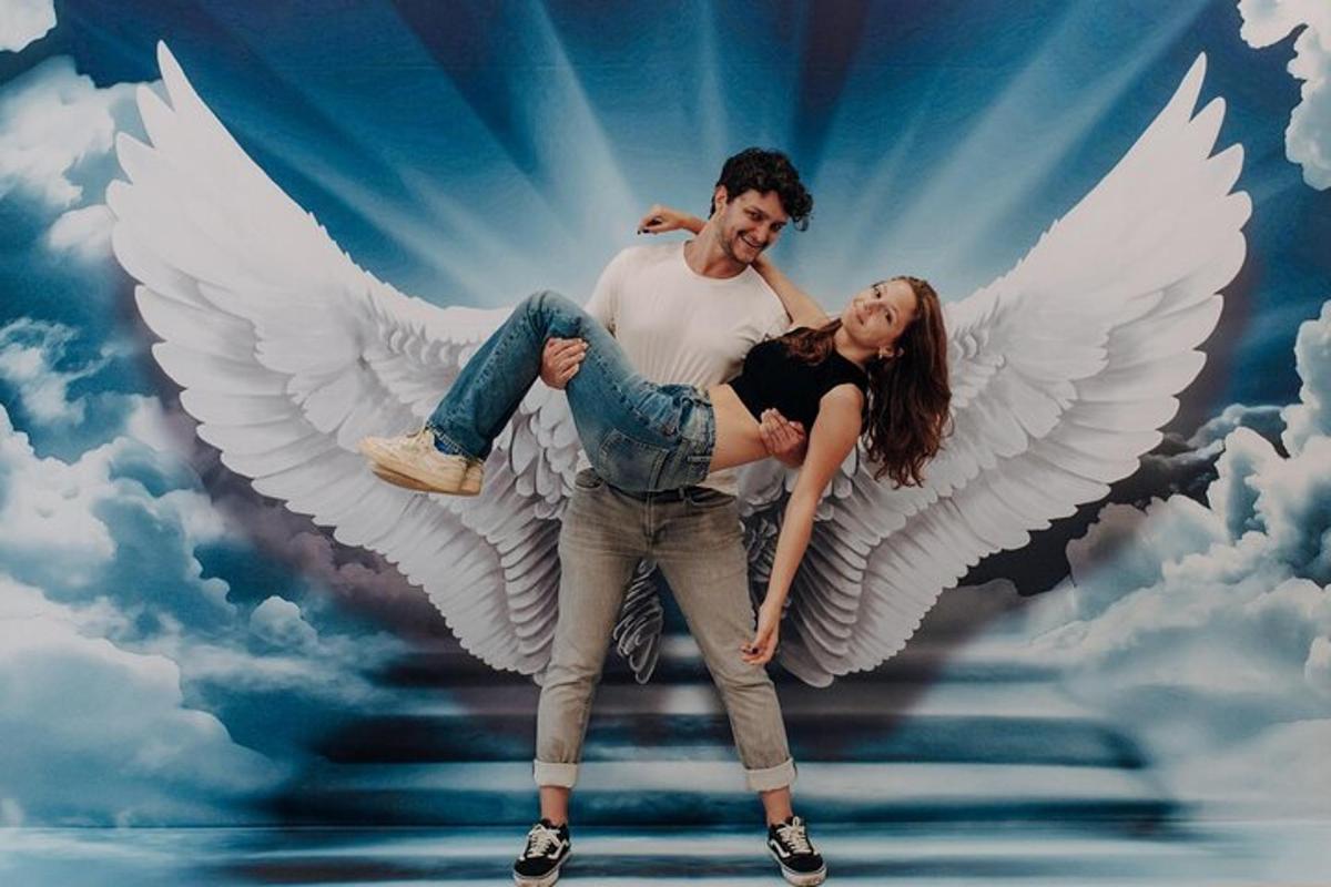 a man and a woman with white angel wings