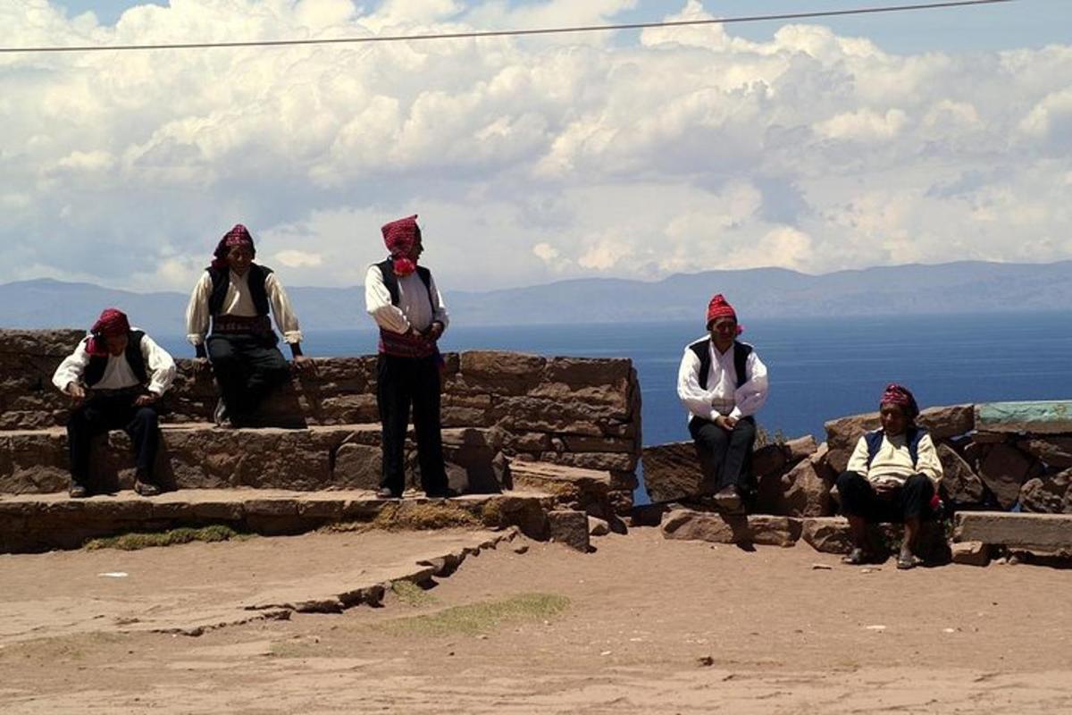 a group of people sitting on some steps near the water