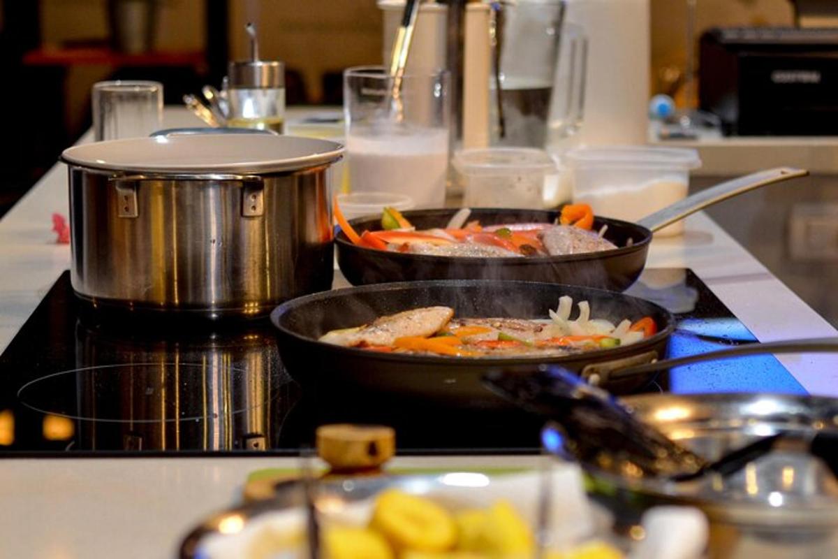 two pans of food on a stove in a kitchen