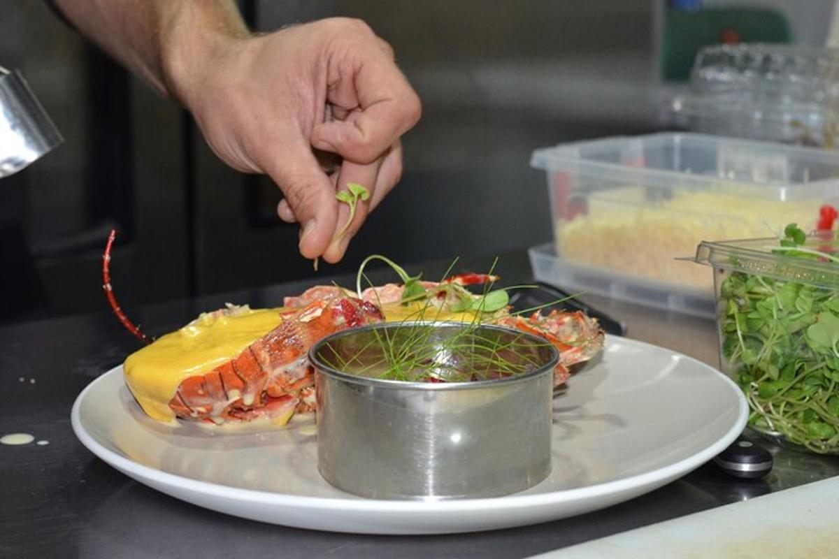 a person is sprinkling sauce on a plate of food