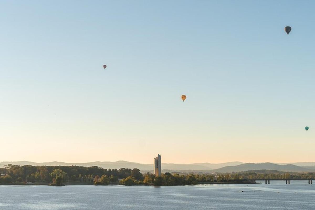 two kites flying over a large body of water