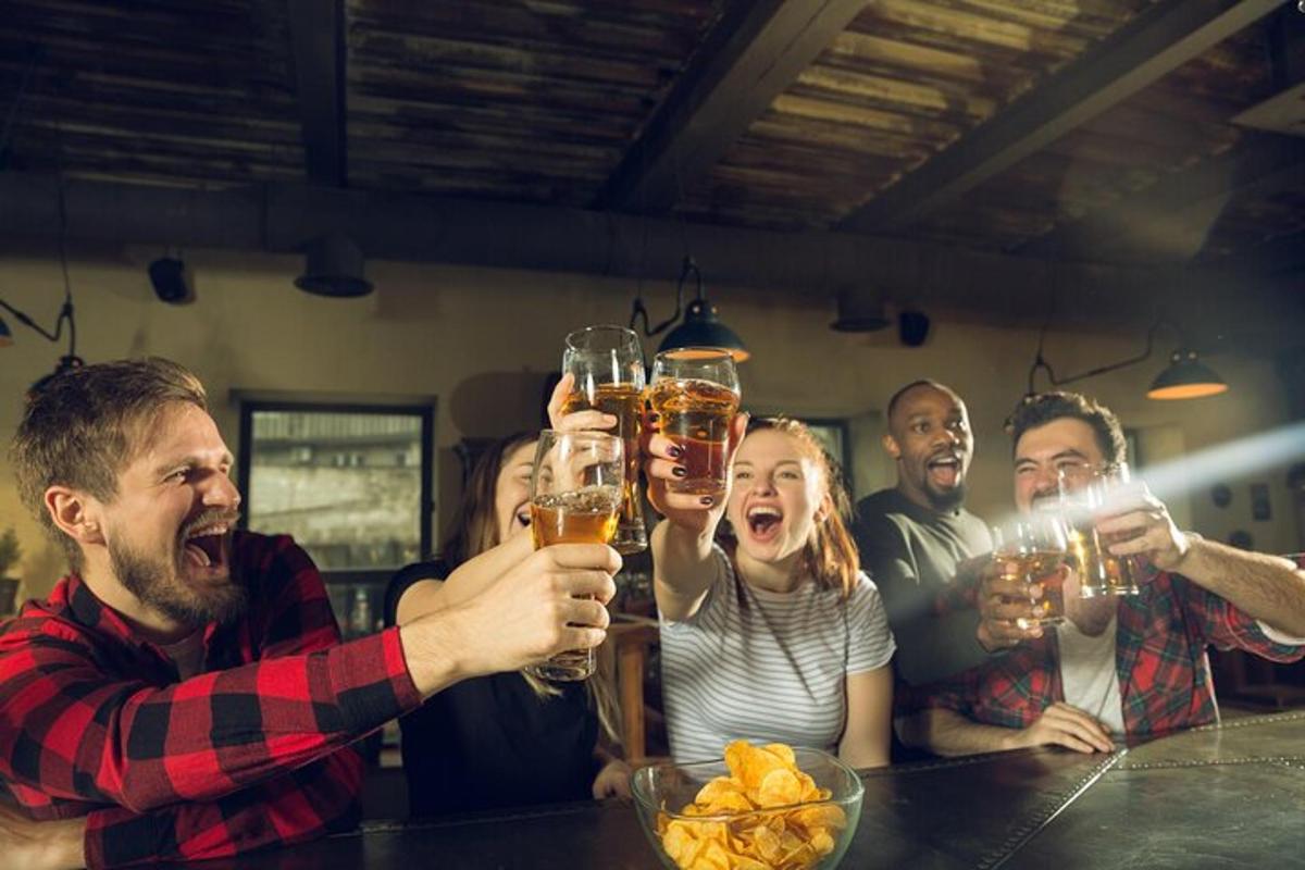 a group of people holding up glasses of beer