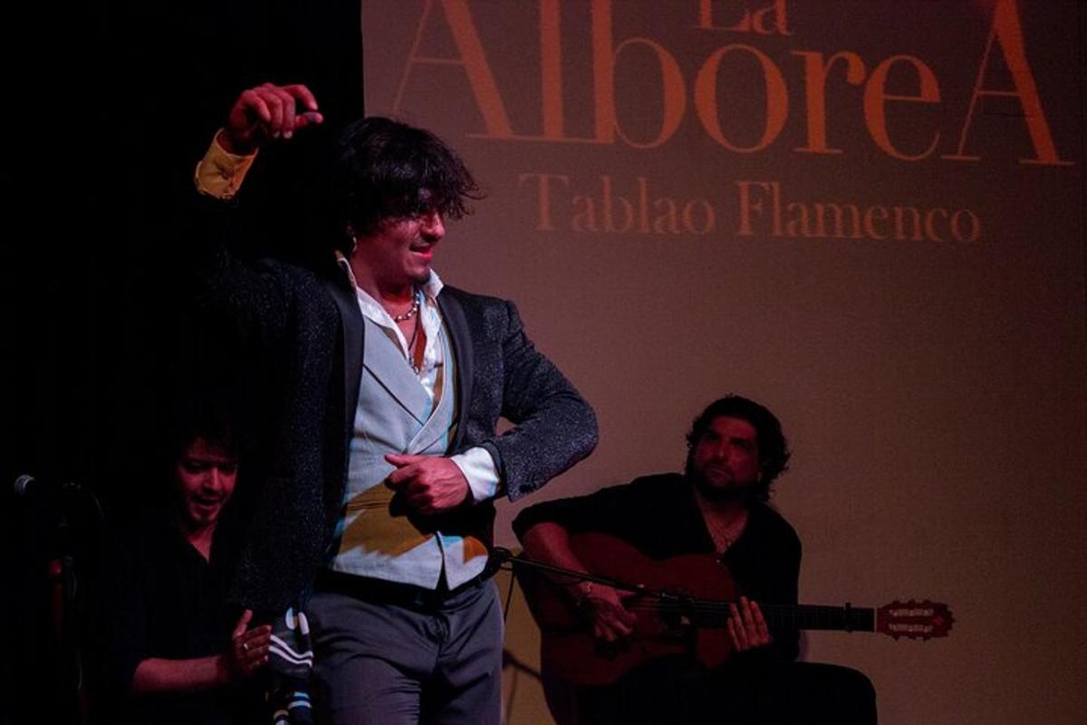 a man standing in front of a stage holding a guitar