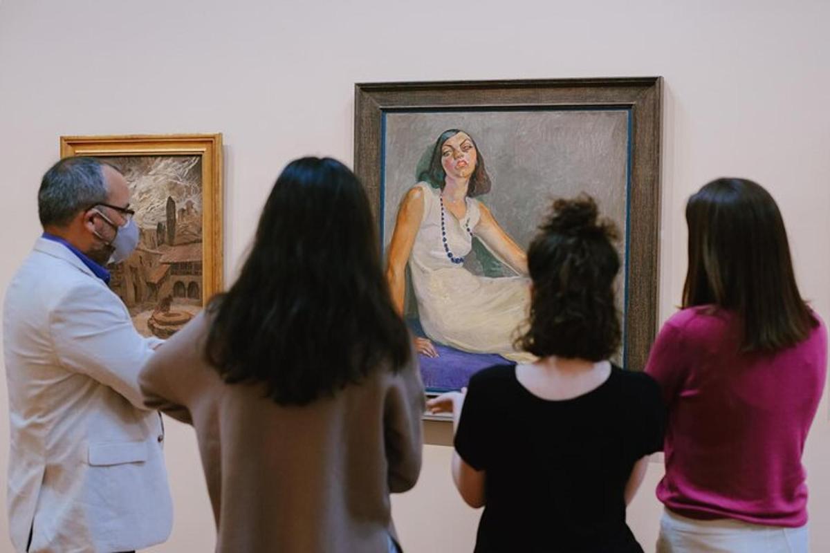 a group of people looking at a painting