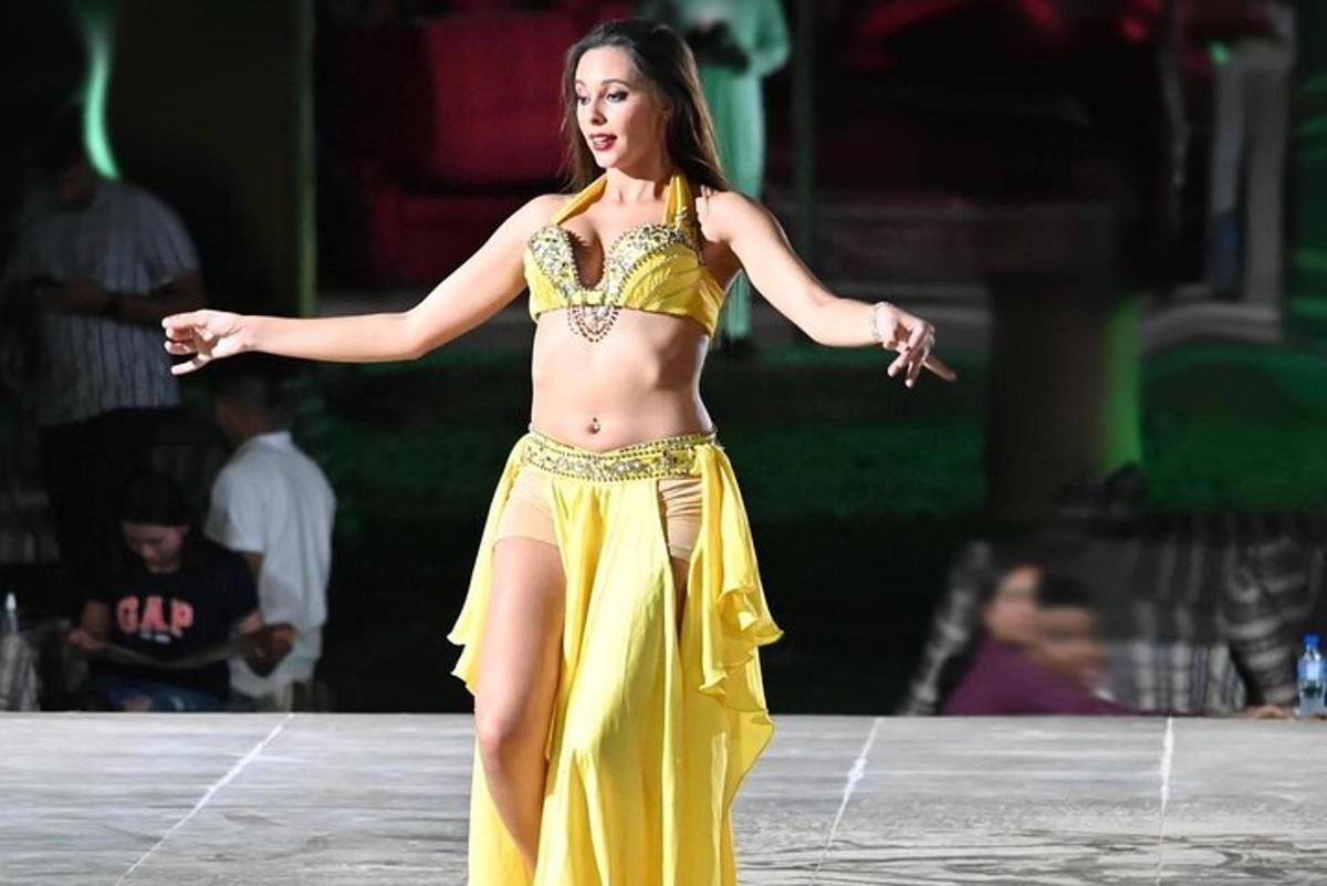 a woman in a yellow dress on a stage