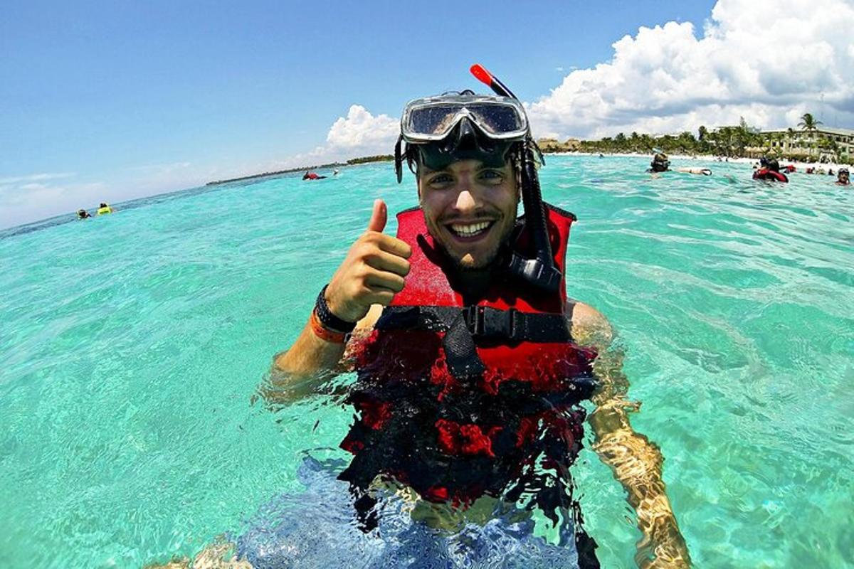 a man in the water giving a thumbs up