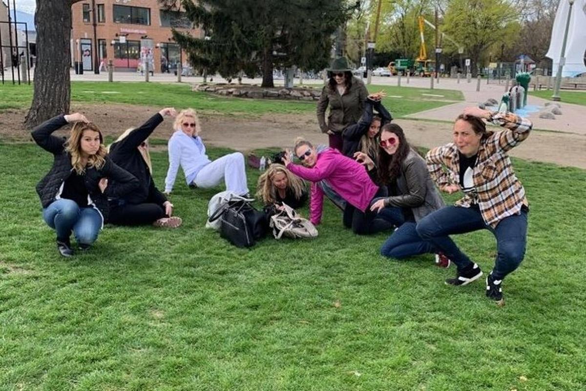 a group of people sitting on the grass in a park