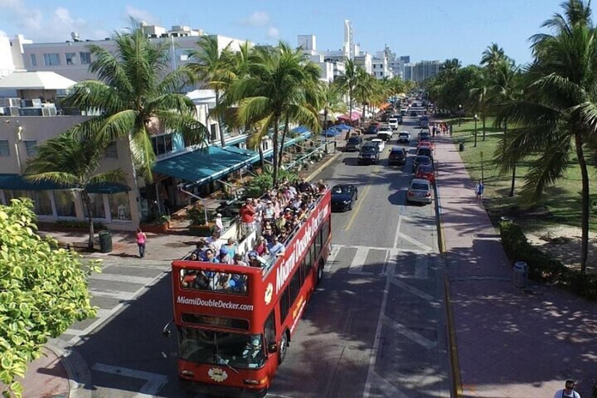 a red double decker bus driving down a street