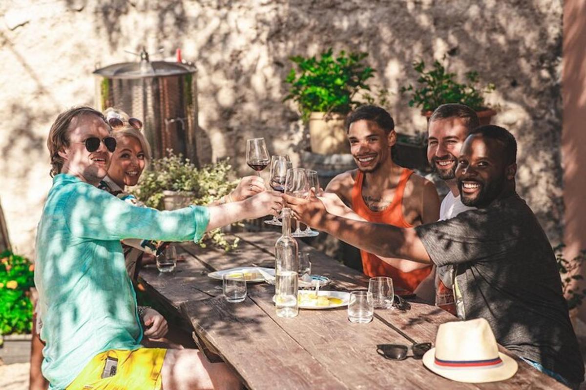 a group of people sitting around a table with wine glasses