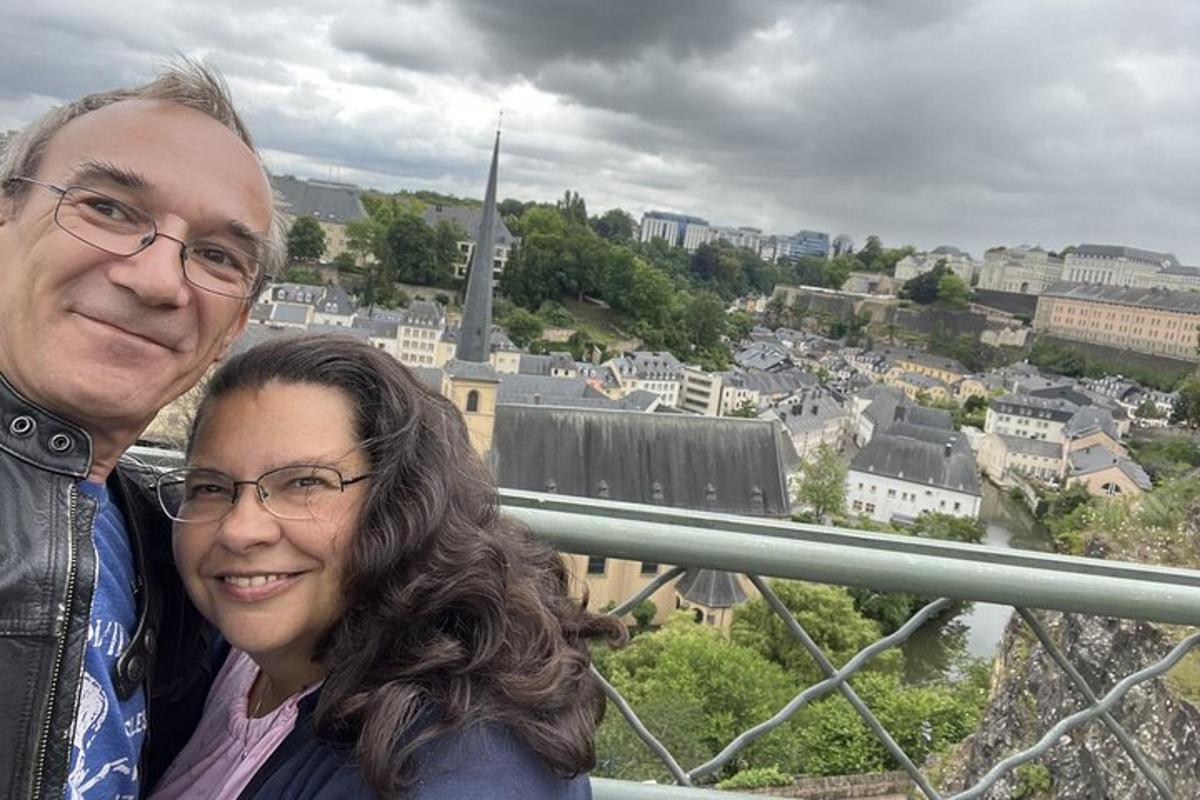 a man and a woman posing for a picture in a city
