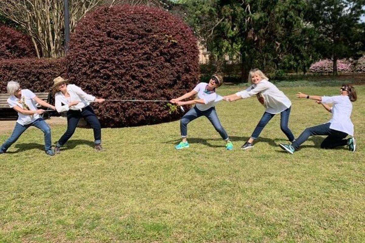 a group of women playing a game of ropeord